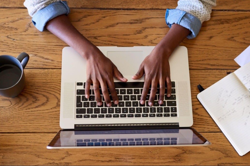 student typing on computer