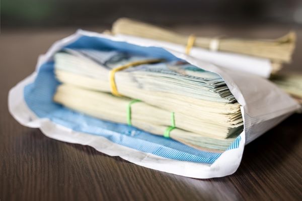 illicit financial flows cash in envelope