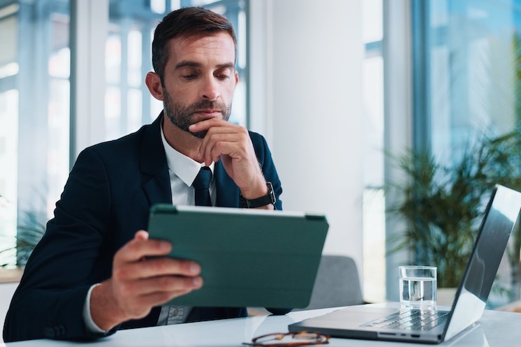 fraud investigator reviewing data on tablet