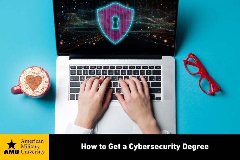 how-to-get-a-cybersecurity-degree-amu cybersecurity degree graduate typing on laptop