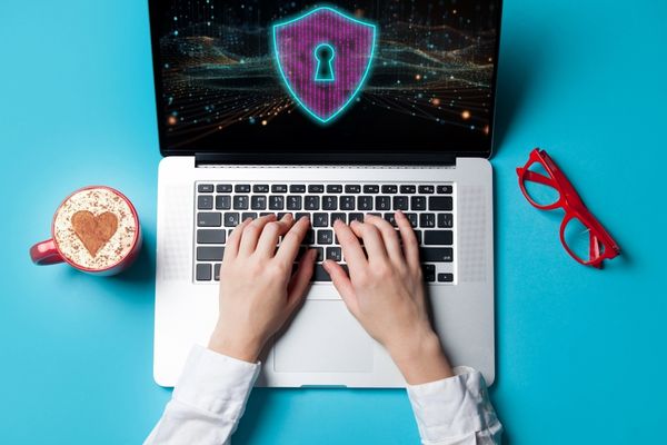 cybersecurity degree graduate typing on laptop