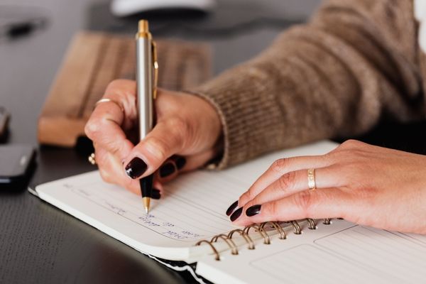 English degree student writing in notebook
