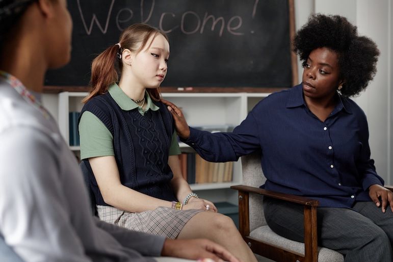 school psychologist comforting student