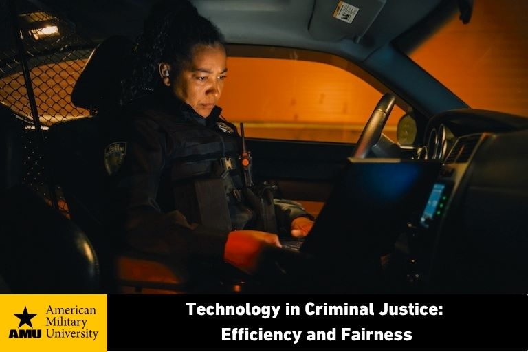 tech-in-criminal-justice female officer sitting in police cruiser looking at laptop