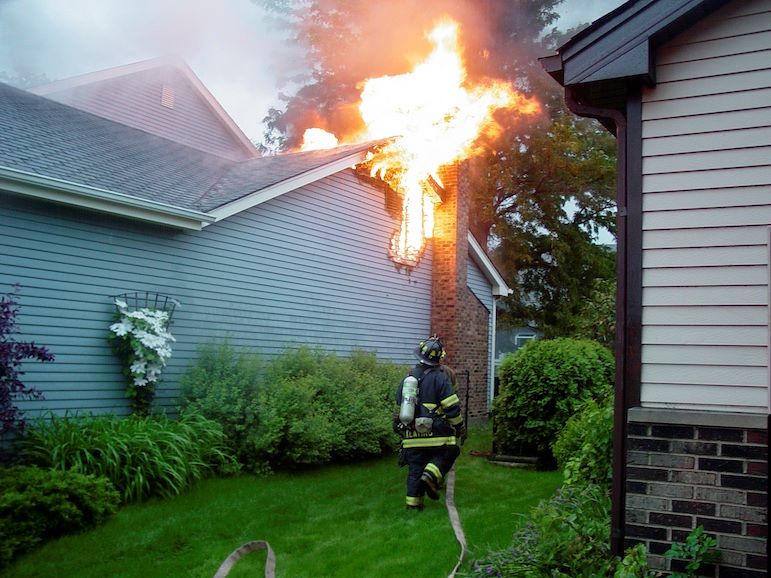 firefighter heading toward house fire