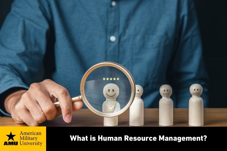 human resource professional holding magnifying glass in front of wooden figure