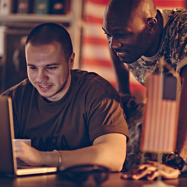 Portrait of two men looking at a laptop