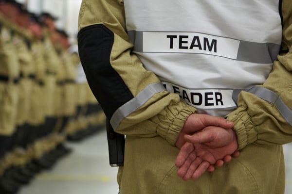 Person with Team Leader  on the back of their uniform