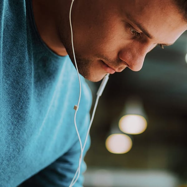 Photo of a man focusing and listening to music