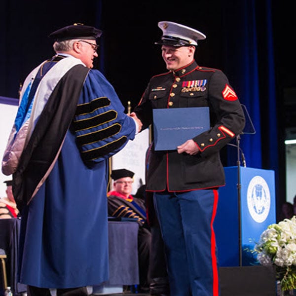 Military student receiving diploma